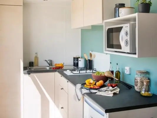 The mobile home kitchen with worktop, microwave and storage