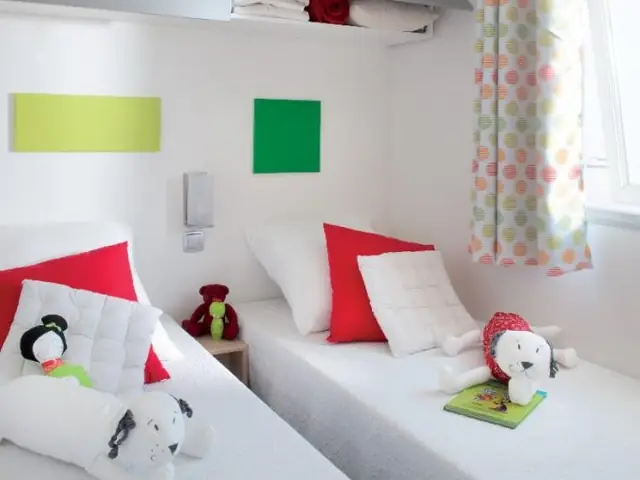 A mobile home bedroom with two single beds