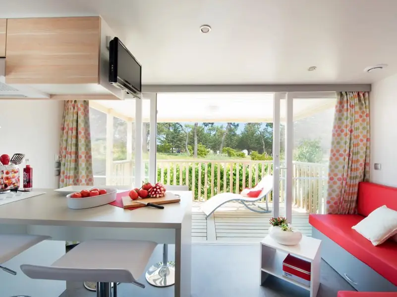 The mobile home kitchen and counter, opening onto the glazed terrace